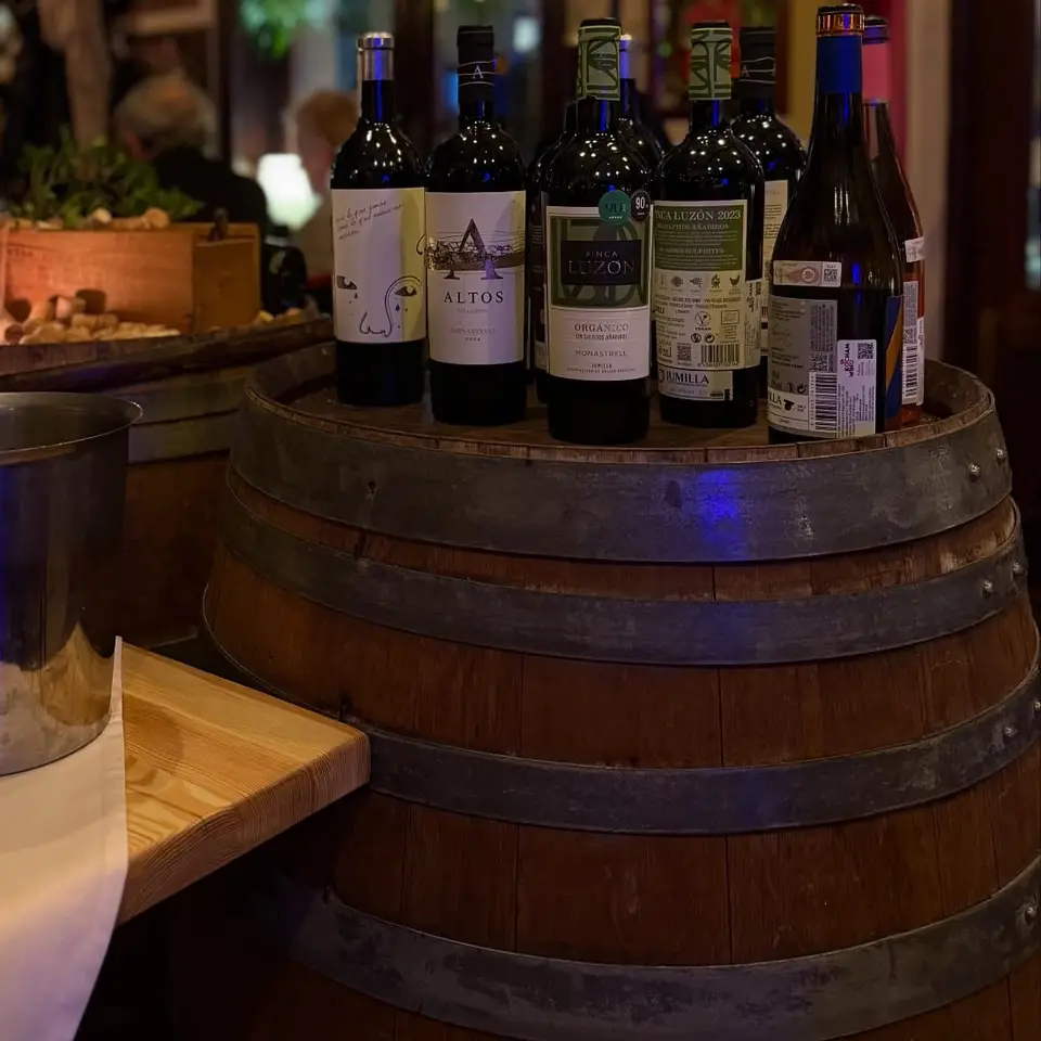 Butelki wina na beczce w sali restauracji